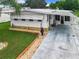 Single-story home with carport and landscaped yard at 824 Silver Oak Ave, The Villages, FL 32159