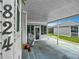Covered patio with grill and access to the home at 824 Silver Oak Ave, The Villages, FL 32159