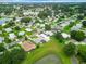 Aerial view of a home located in a community by a lake at 824 Silver Oak Ave, The Villages, FL 32159