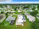 Aerial view highlighting the home's position in a residential neighborhood near a lake at 824 Silver Oak Ave, The Villages, FL 32159