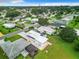 Aerial view showcasing a home with solar panels in a quiet, residential neighborhood at 824 Silver Oak Ave, The Villages, FL 32159