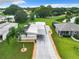 Aerial view of a single-story home with a driveway and a landscaped yard at 824 Silver Oak Ave, The Villages, FL 32159