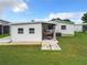 White garage with covered patio and storage area at 824 Silver Oak Ave, The Villages, FL 32159