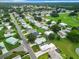 Aerial view showcasing home's location in a community near a golf course and lake at 824 Silver Oak Ave, The Villages, FL 32159
