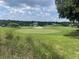 View of a lush green golf course with a sand trap and putting green at 824 Silver Oak Ave, The Villages, FL 32159