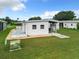 White garage with covered patio and storage area at 824 Silver Oak Ave, The Villages, FL 32159