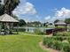 Community lake with gazebo, dock, and bench at 824 Silver Oak Ave, The Villages, FL 32159