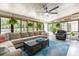 Bright and airy sunroom with a large sectional sofa and plenty of natural light at 3660 Grand Ave, Deland, FL 32720