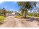 Gravel driveway leading to a unique home with a large yard at 3660 Grand Ave, Deland, FL 32720