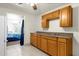 Kitchen with wood cabinets and view into bedroom at 3660 Grand Ave, Deland, FL 32720