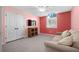 Cozy bedroom with a sofa, TV, and ample closet space at 3457 Martingale Ct, Port Orange, FL 32129