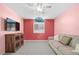 Bedroom with pink walls, and a ceiling fan at 3457 Martingale Ct, Port Orange, FL 32129