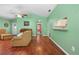 Open living room with hardwood floors and access to kitchen at 3457 Martingale Ct, Port Orange, FL 32129