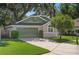 House exterior with green garage door and landscaping at 3457 Martingale Ct, Port Orange, FL 32129
