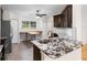 Renovated kitchen with granite countertops, dark cabinets, and an island at 288 Silverstone Dr, Orange City, FL 32763