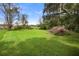 Large backyard with grassy area and mature trees at 288 Silverstone Dr, Orange City, FL 32763