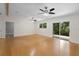 Open concept living room with hardwood floors and sliding glass doors at 288 Silverstone Dr, Orange City, FL 32763