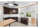 Modern kitchen with granite countertops, stainless steel appliances, and dark wood cabinets at 288 Silverstone Dr, Orange City, FL 32763