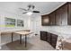 Renovated kitchen with granite countertops, dark cabinets, and an island at 288 Silverstone Dr, Orange City, FL 32763