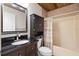 Bathroom with dark vanity, shower/tub combo and linen cabinet at 288 Silverstone Dr, Orange City, FL 32763