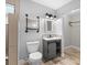 Modern bathroom with gray vanity, floating shelves, and toilet at 288 Silverstone Dr, Orange City, FL 32763