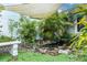 Relaxing backyard oasis with pond, shade sail, and lush landscaping at 3435 Arabesque Dr, Deland, FL 32724