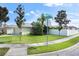 One-story house with a green exterior, two-car garage, and green lawn at 3435 Arabesque Dr, Deland, FL 32724