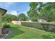Landscaped backyard with lush lawn and privacy wall at 47 Villa Villar Ct # 470, Deland, FL 32724
