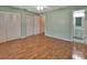Bright bedroom featuring laminate floors and ample closet space at 47 Villa Villar Ct # 470, Deland, FL 32724
