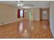 Large living room with hardwood floors and views into the kitchen and entryway at 47 Villa Villar Ct # 470, Deland, FL 32724