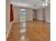 Open living room with hardwood floors and access to kitchen and entry at 47 Villa Villar Ct # 470, Deland, FL 32724