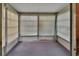 Bright sunroom with window blinds and carpeted flooring at 47 Villa Villar Ct # 470, Deland, FL 32724