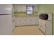 Efficient kitchen with white cabinets, appliances, and ample counter space at 47 Villa Villar Ct # 470, Deland, FL 32724