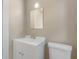 Clean bathroom with white vanity, toilet, and a framed mirror at 2300 Calloway Dr, Orlando, FL 32810