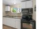 Bright kitchen featuring white cabinets, new flooring, and modern appliances at 2300 Calloway Dr, Orlando, FL 32810