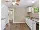 Kitchen with white cabinets, a double sink, and access to other rooms at 2300 Calloway Dr, Orlando, FL 32810