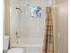 Simple bathroom with white subway tiles, shower/tub combo and window at 2300 Calloway Dr, Orlando, FL 32810