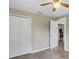Bedroom with hardwood floor, ceiling fan, and white closet doors at 2300 Calloway Dr, Orlando, FL 32810