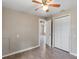 Bright bedroom with ceiling fan, hardwood floors, and access to a closet at 2300 Calloway Dr, Orlando, FL 32810