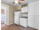 White kitchen cabinets and appliances, and light brown vinyl flooring at 2300 Calloway Dr, Orlando, FL 32810