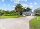 Gray house with a palm tree and a long driveway at 2300 Calloway Dr, Orlando, FL 32810