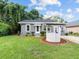 Charming gray house with a white well and landscaping at 2300 Calloway Dr, Orlando, FL 32810