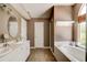 Bathroom with double vanity, garden tub, and large window at 4205 Quail Ranch Rd, New Smyrna Beach, FL 32168