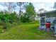 Screened patio with grill, grassy yard at 4205 Quail Ranch Rd, New Smyrna Beach, FL 32168