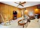 Living area with a rocking chair and wood paneled walls at 106 N Frederick St, Pierson, FL 32180