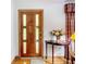 Wood front door with sidelights and entry table at 106 N Frederick St, Pierson, FL 32180