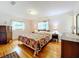 Main bedroom with floral bedding and hardwood floors at 106 N Frederick St, Pierson, FL 32180