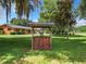 Quaint wooden well with bucket in the front yard at 106 N Frederick St, Pierson, FL 32180
