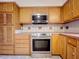 Updated kitchen with stainless steel appliances and wood cabinets at 106 N Frederick St, Pierson, FL 32180