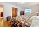 Main bedroom with floral bedding and hardwood floors at 106 N Frederick St, Pierson, FL 32180